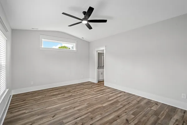 a view of a livingroom with a ceiling fan and wooden floor
