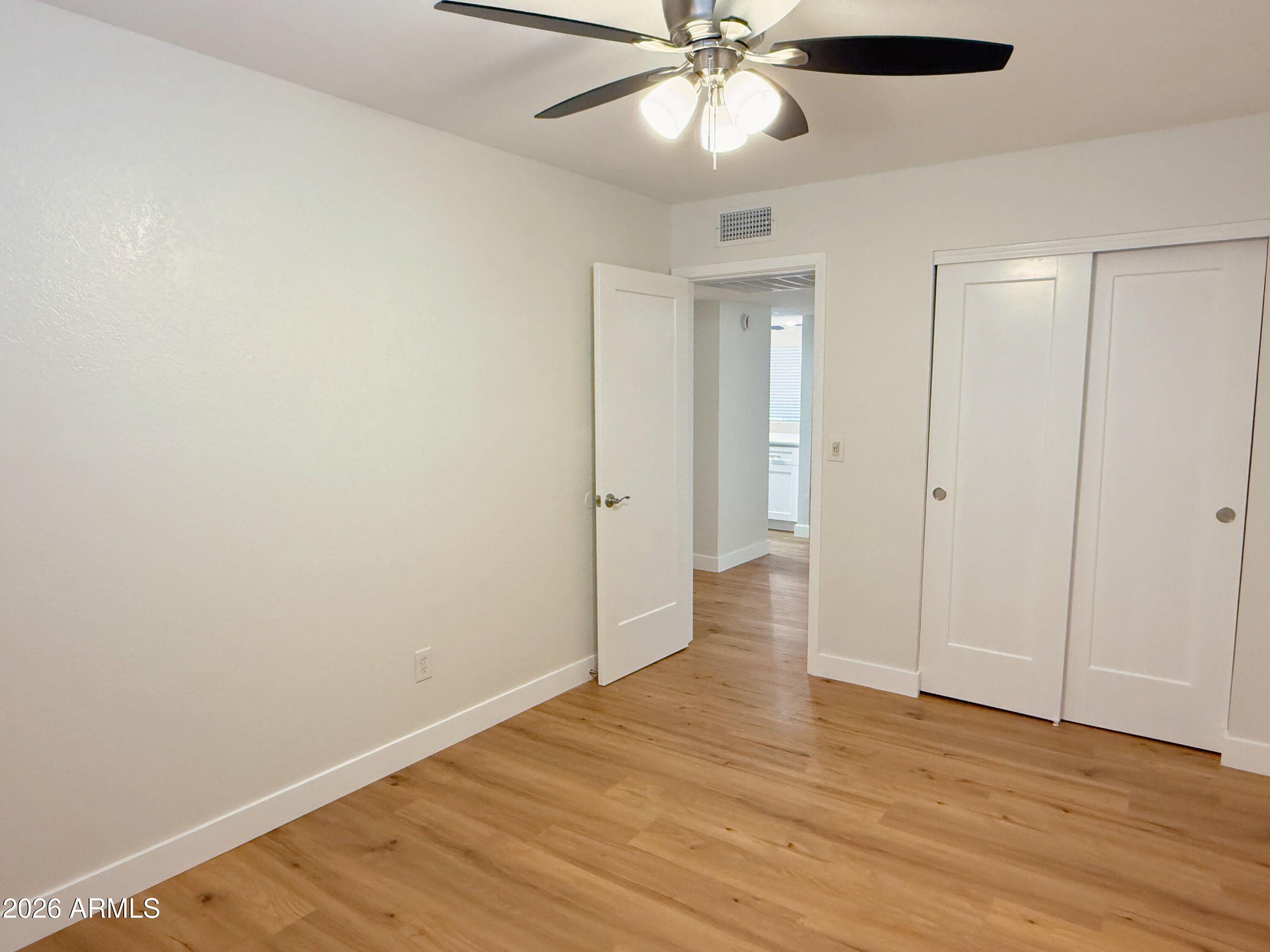 18202 North Cave Creek Road, Unit 148 Phoenix, AZ 85032 - Photo 14 of 19 wooden floor in an empty room