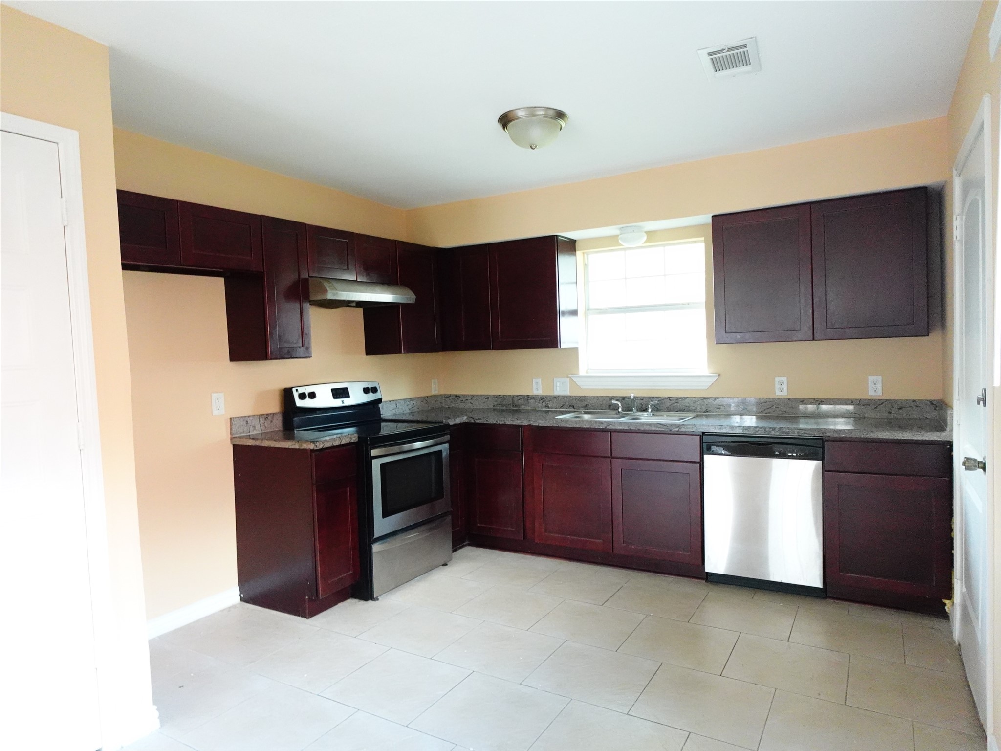 4721 Denmark Street Houston, TX 77016 - Photo 3 of 6 a kitchen with granite countertop stainless steel appliances and cabinets