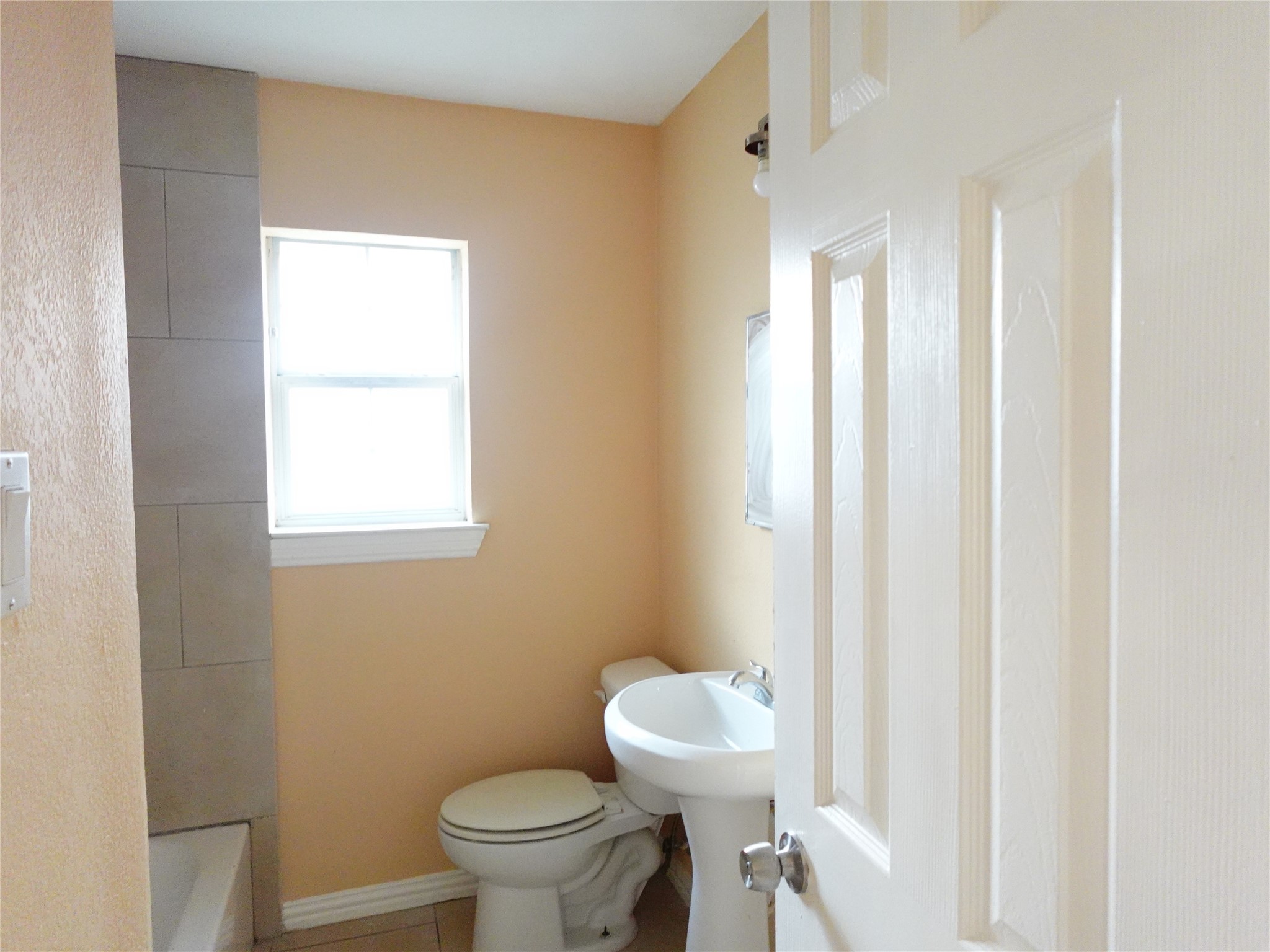 4721 Denmark Street Houston, TX 77016 - Photo 6 of 6 a white toilet sitting next to a bathroom sink