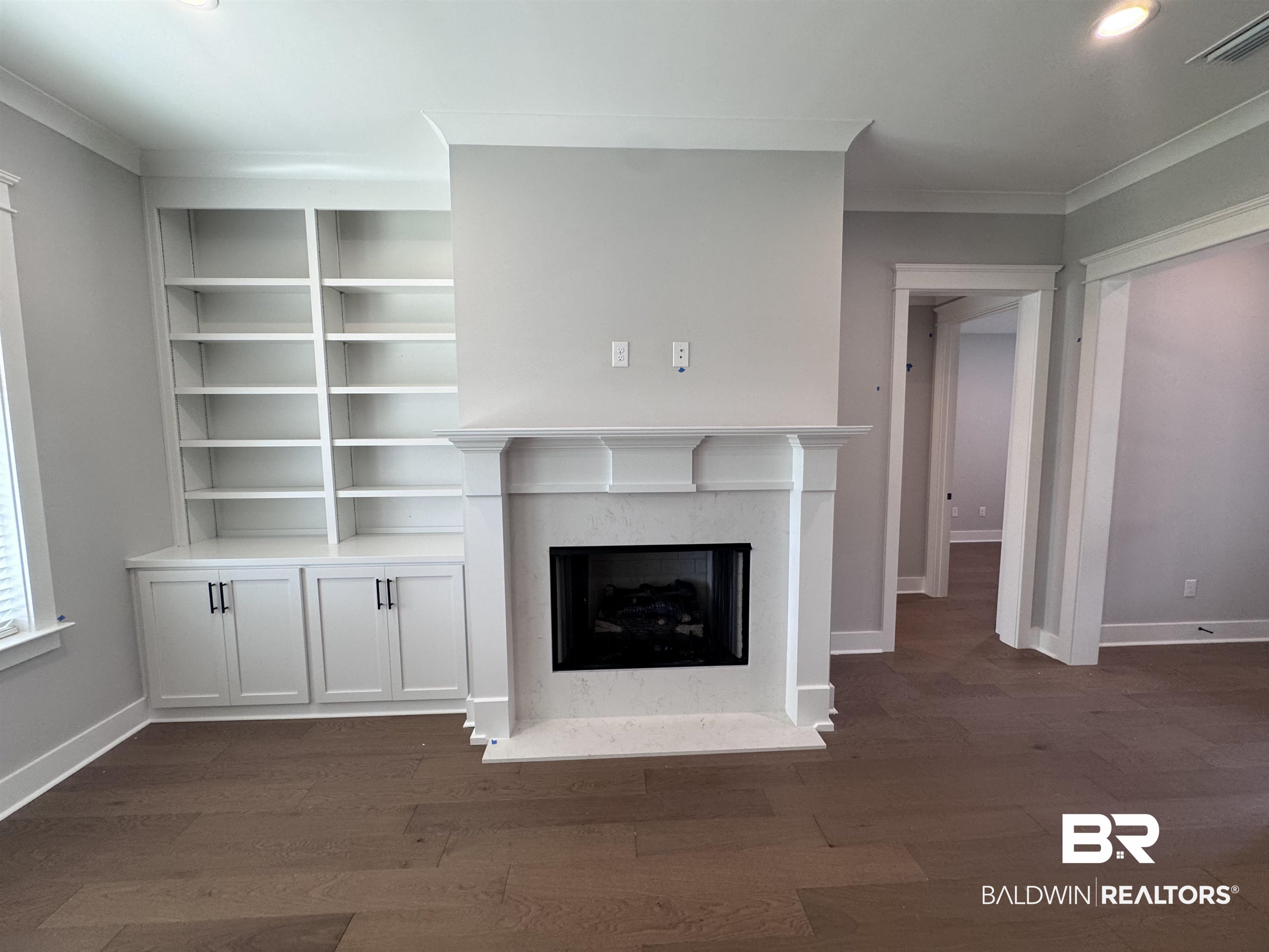 27371 Patch Pl Loop Daphne, AL 36526 - Photo 17 of 63 Unfurnished living room featuring crown molding, dark wood-type flooring, a fireplace, and recessed lighting
