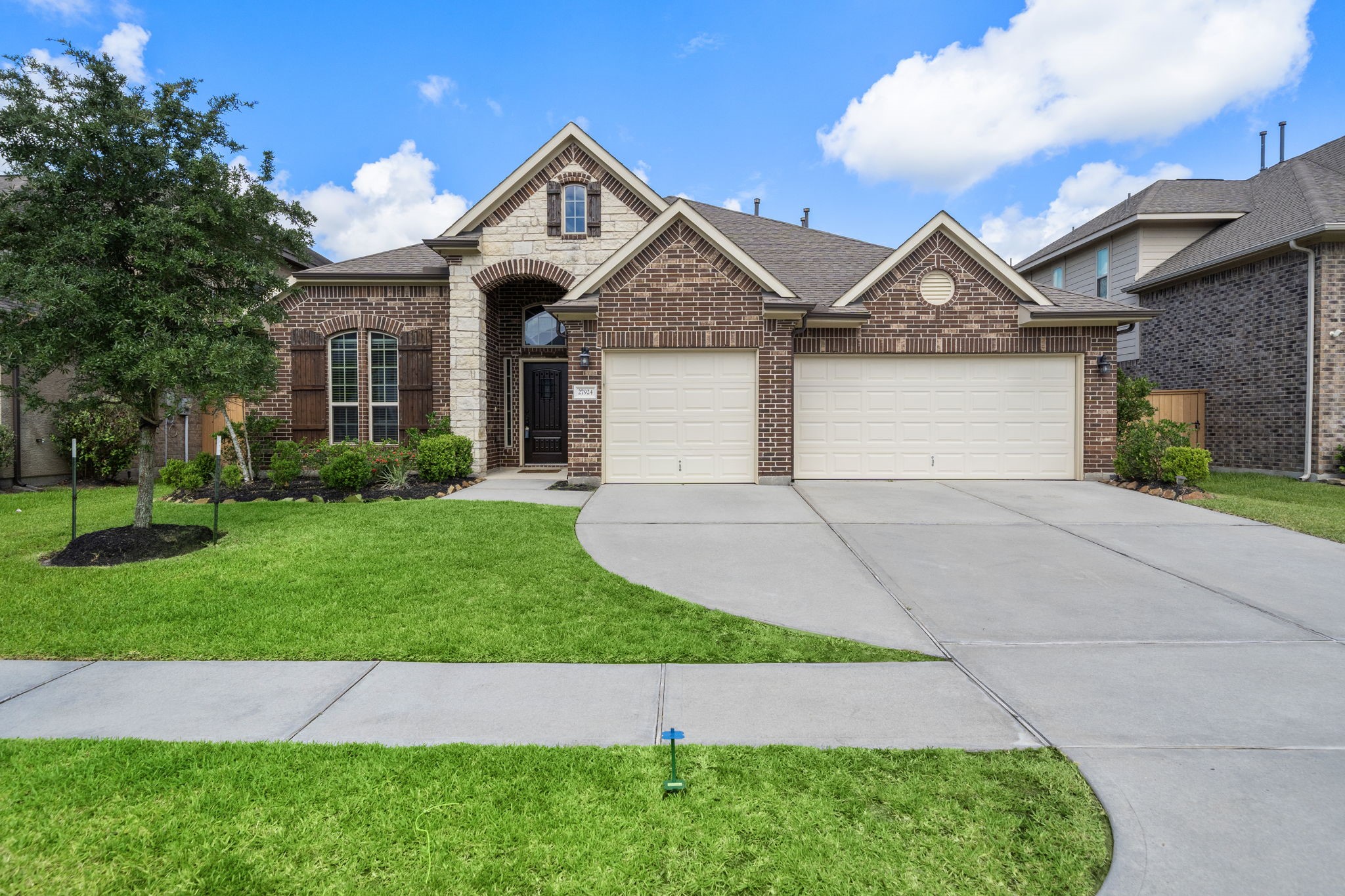 27924 Seger Bnd Trail Spring, TX 77386 - Photo 2 of 21 This charming single-story brick home is with a well-maintained front lawn, a three-car garage, and a welcoming entryway. The house features a combination of brick and stone accents, providing a classic and elegant curb appeal.