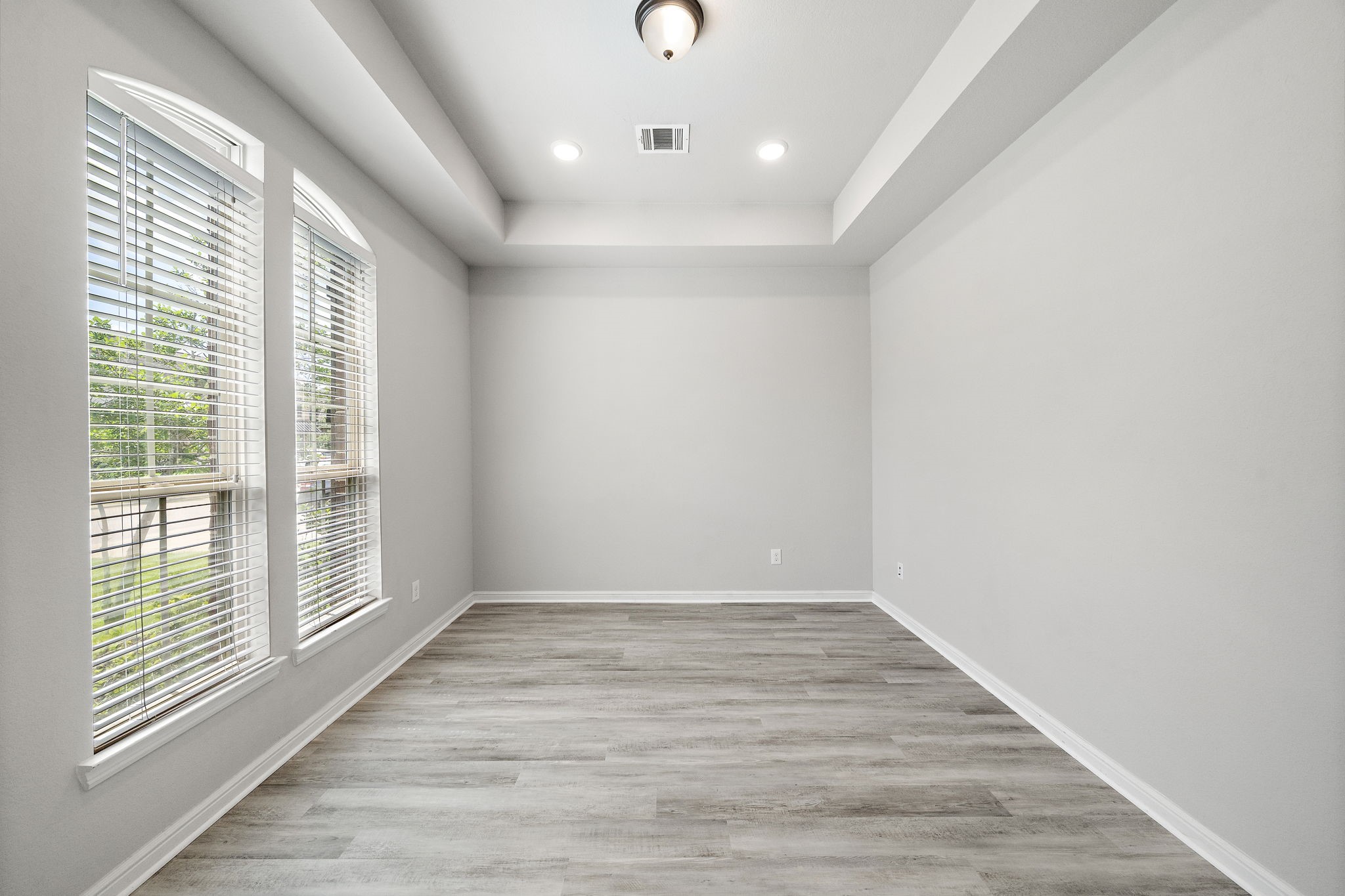 27924 Seger Bnd Trail Spring, TX 77386 - Photo 6 of 21 Bright room with large windows, modern light fixture, and light wood flooring. Ideal for an office or additional living space.