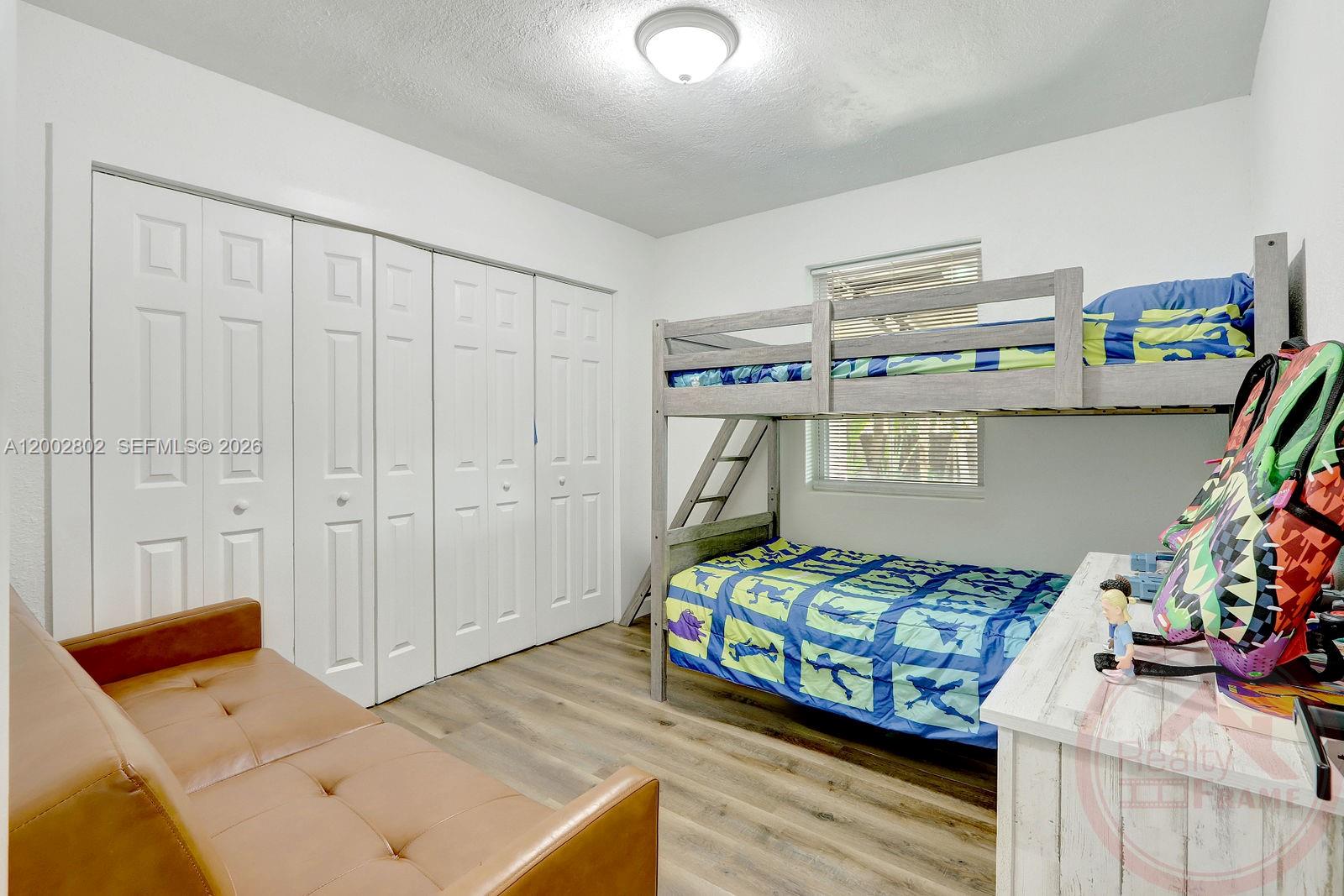 11240 Southwest 60th Terrace Miami, FL 33173 - Photo 12 of 19 a bedroom with a bed and a couch