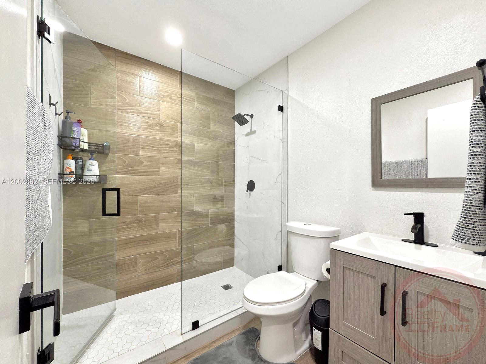 11240 Southwest 60th Terrace Miami, FL 33173 - Photo 4 of 19 a bathroom with a sink a toilet and shower
