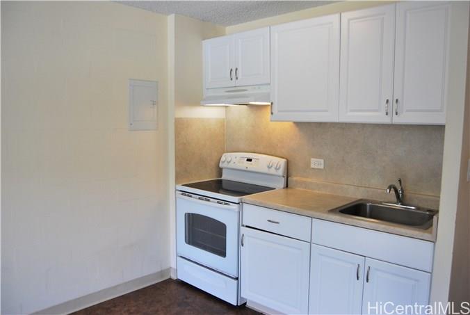 1718 Anapuni Street, Unit 502 Honolulu, HI 96822 - Photo 2 of 9 a kitchen with white cabinets and white appliances
