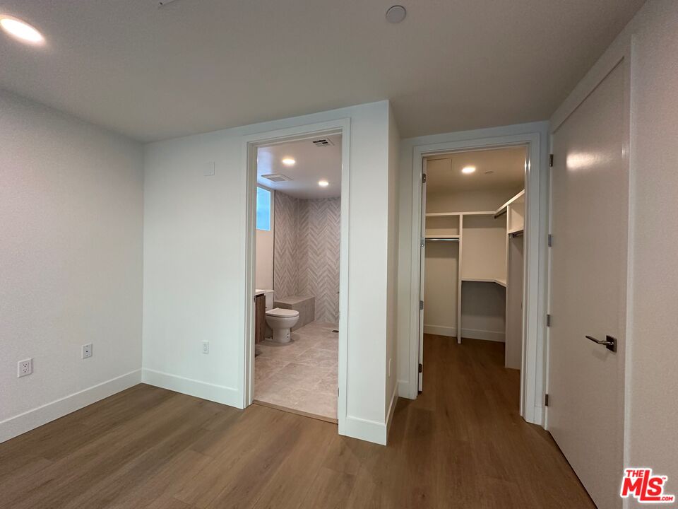 3649 Regal Place, Unit 307 Los Angeles, CA 90068 - Photo 12 of 24 a view of a room with wooden floor cabinet and a bathroom