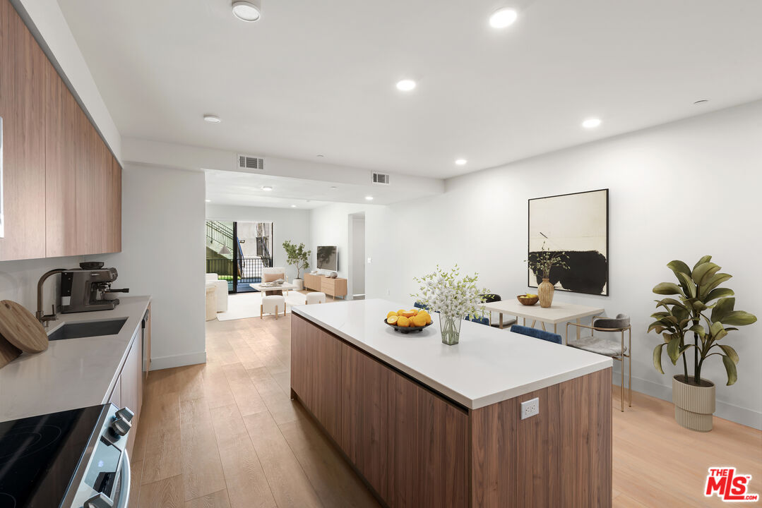 3649 Regal Place, Unit 307 Los Angeles, CA 90068 - Photo 7 of 24 a kitchen with a sink stove and wooden floor