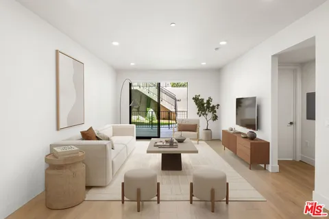 a living room with fireplace furniture and a flat screen tv