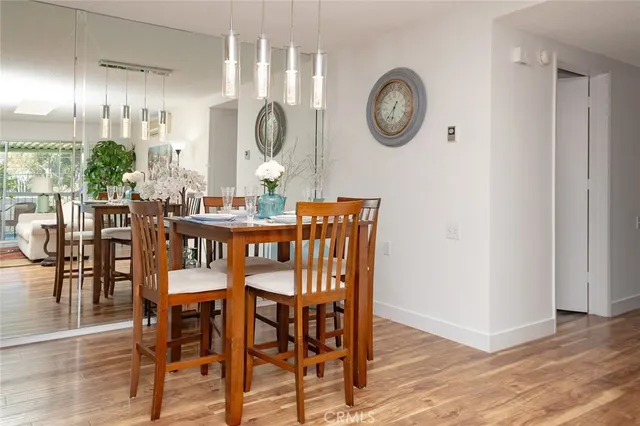 a dining area with furniture window and wooden floor