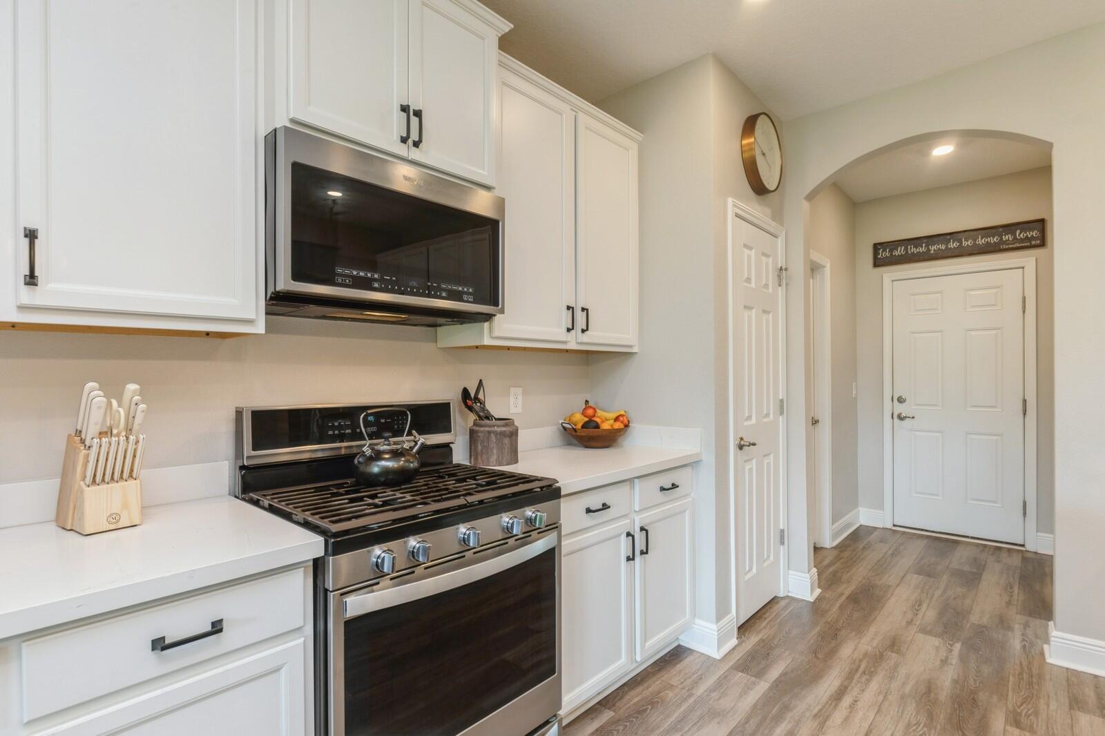 254 Concert Court Freeport, FL 32439 - Photo 14 of 69 a kitchen with stainless steel appliances a stove a microwave and cabinets