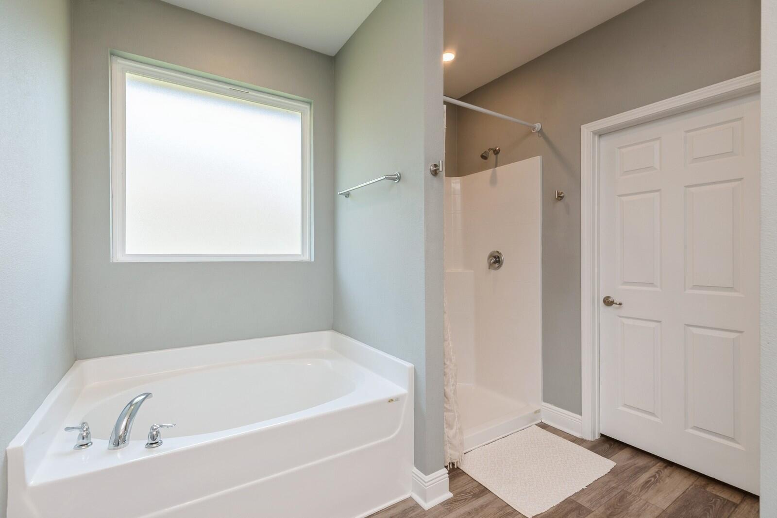 254 Concert Court Freeport, FL 32439 - Photo 22 of 69 a white bath tub sitting next to a window