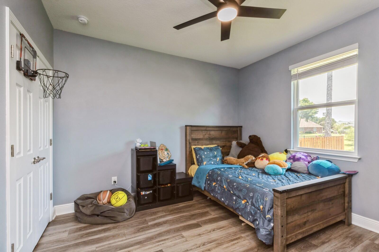 254 Concert Court Freeport, FL 32439 - Photo 24 of 69 a bedroom with a bed and ceiling fan