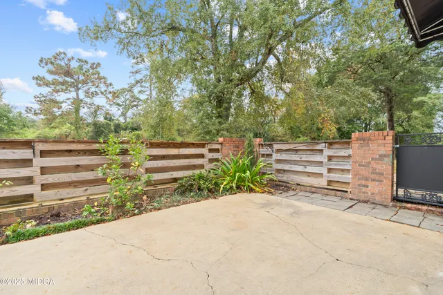 a backyard of a house with outdoor seating