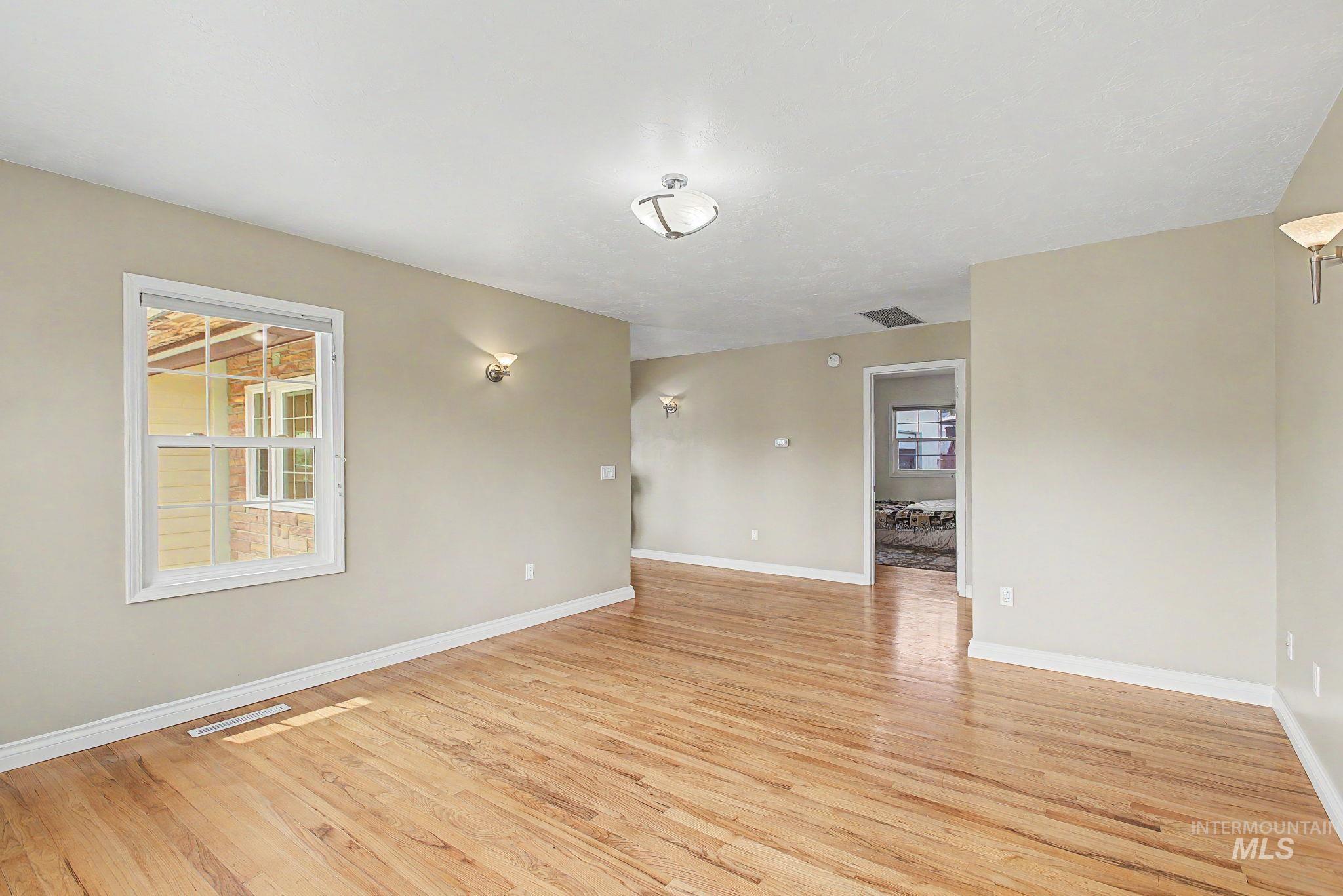 3314 6th Street Lewiston, ID 83501 - Photo 9 of 50 Open concept room featuring wood-finish flooring, neutral-toned walls, and white baseboards