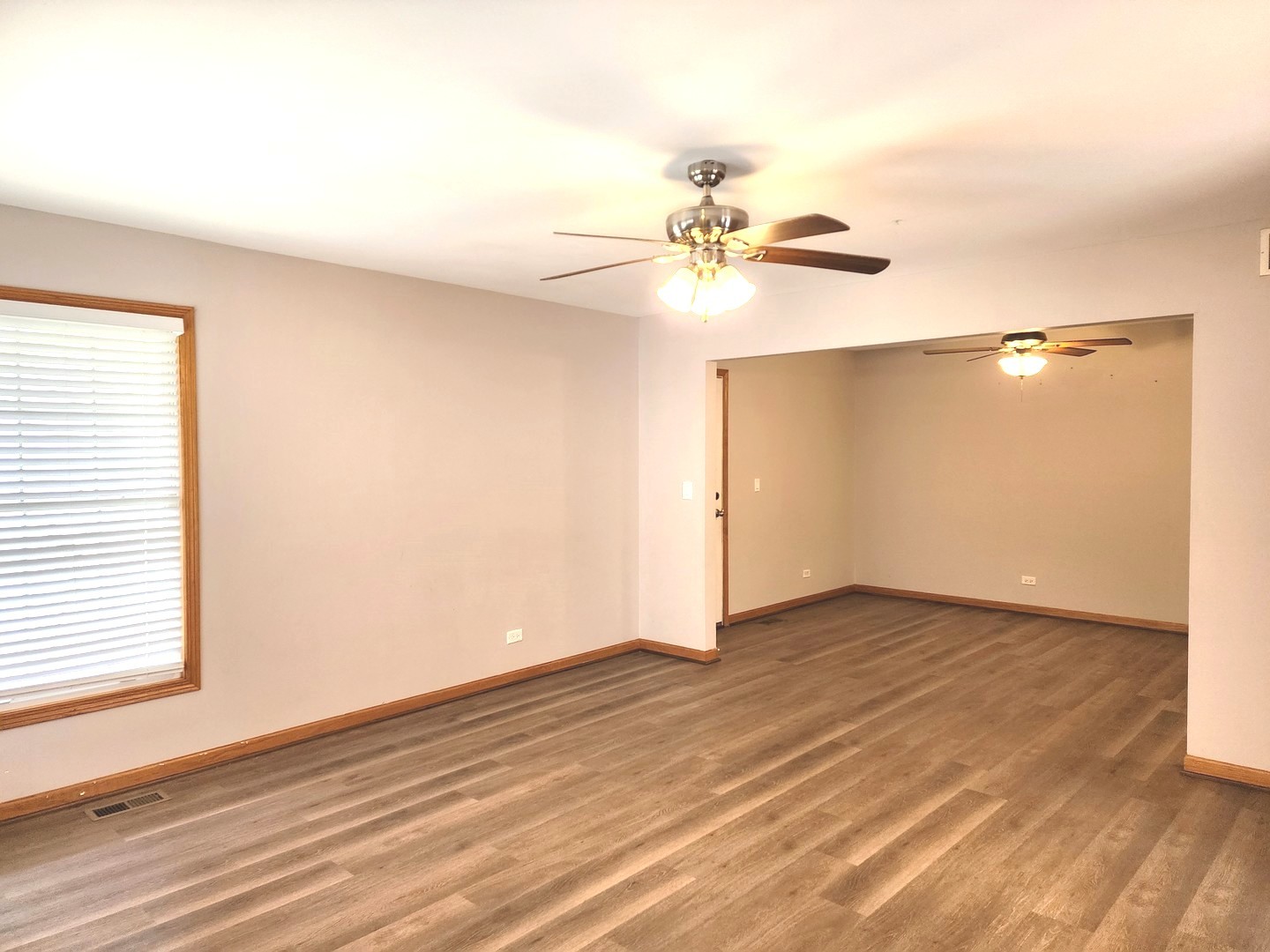 532 Elizabeth Street Maple Park, IL 60151 - Photo 3 of 14 an empty room with wooden floor fan and windows