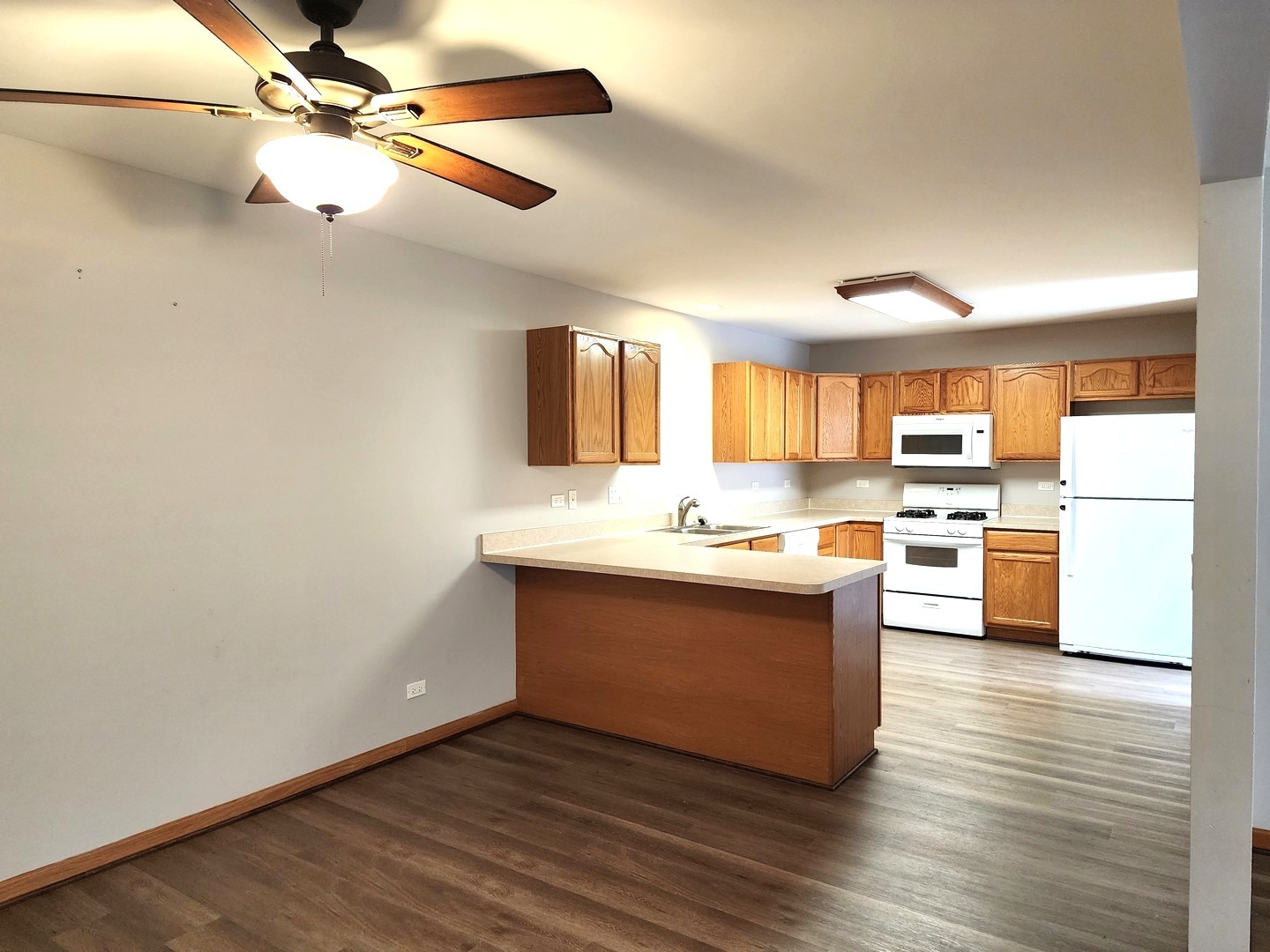 532 Elizabeth Street Maple Park, IL 60151 - Photo 7 of 14 a view with kitchen island wooden floors stainless steel appliances and a window