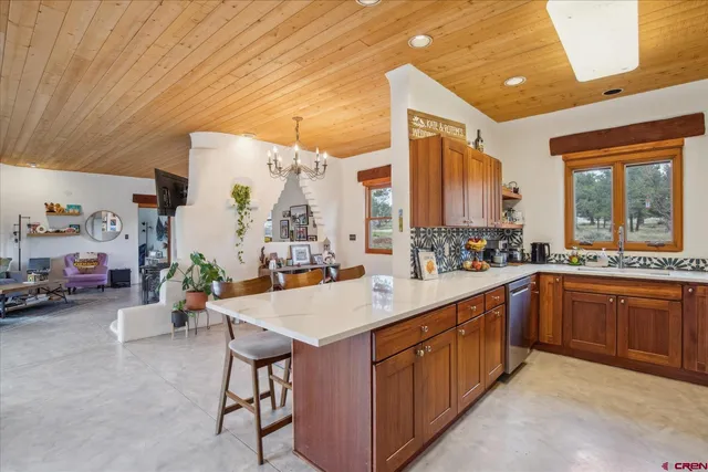 a large kitchen with kitchen island a large counter space sink and stove