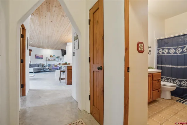 a view of a hallway with kitchen and refrigerator