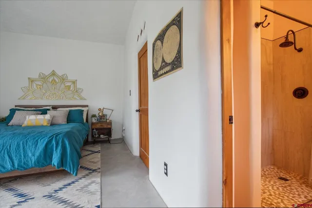 a bedroom with a bed and a table in it