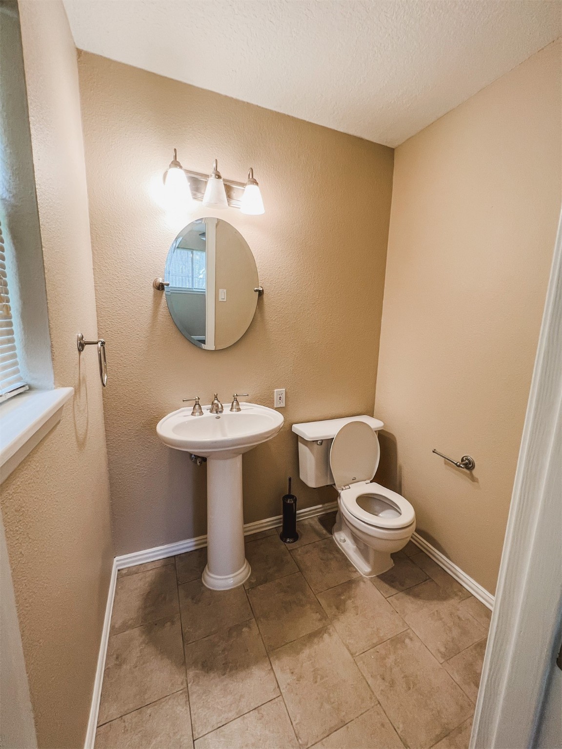 724 Gubert Lane Alvin, TX 77511 - Photo 11 of 15 a bathroom with a sink toilet and a mirror
