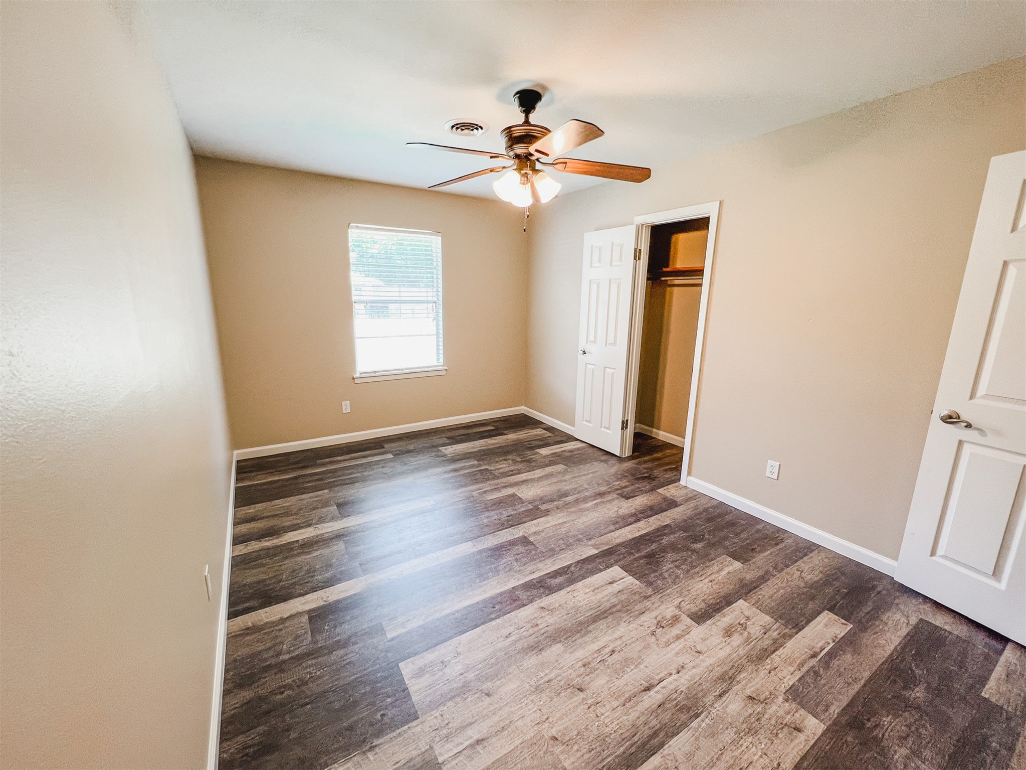 724 Gubert Lane Alvin, TX 77511 - Photo 13 of 15 a view of an empty room with wooden floor and a window