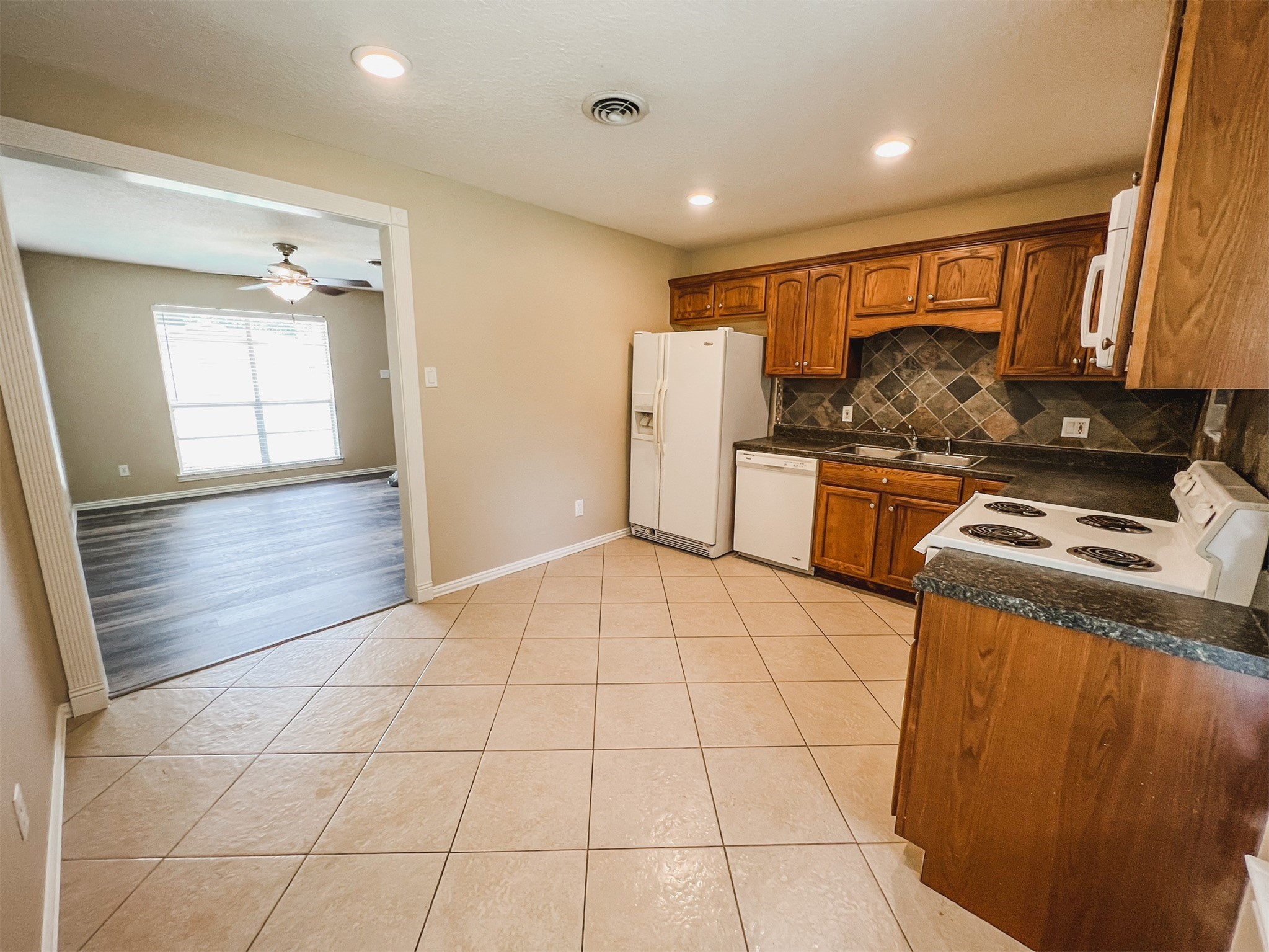 724 Gubert Lane Alvin, TX 77511 - Photo 4 of 15 a kitchen with stainless steel appliances granite countertop a stove a sink and a refrigerator