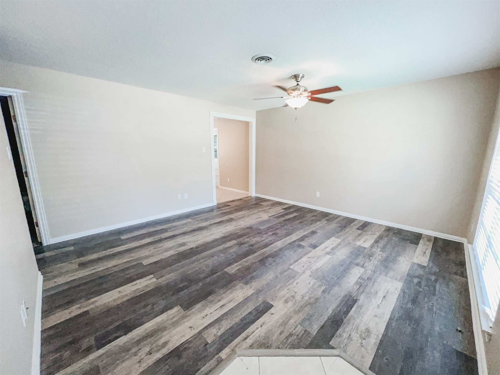 724 Gubert Lane Alvin, TX 77511 - Photo 7 of 15 a view of a room with wooden floor and ceiling fan