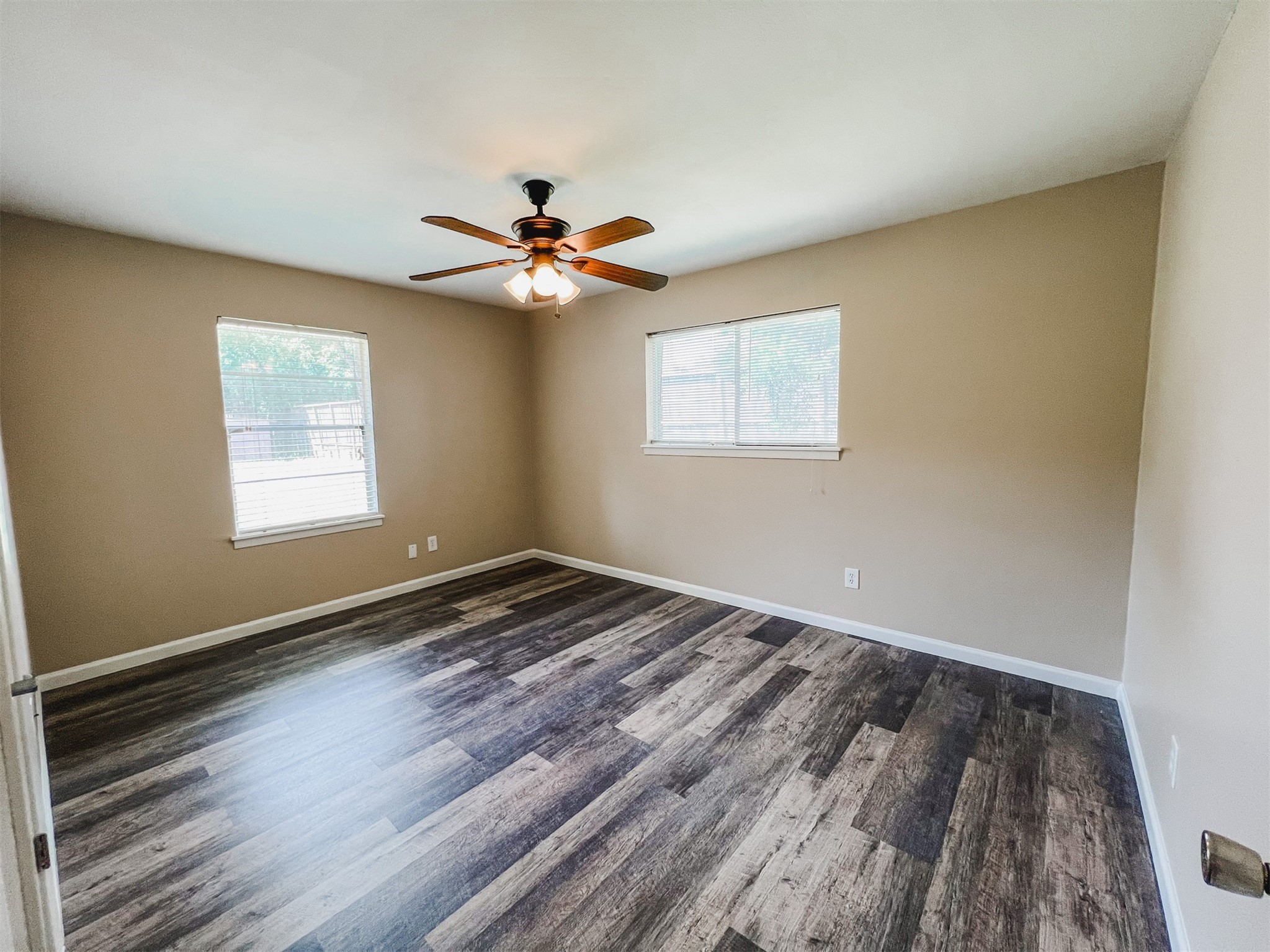 724 Gubert Lane Alvin, TX 77511 - Photo 9 of 15 a view of empty room with wooden floor and fan