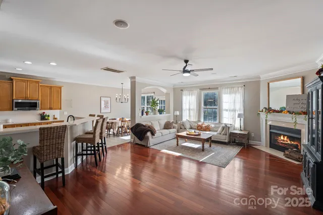 a living room with furniture wooden floor and a fireplace