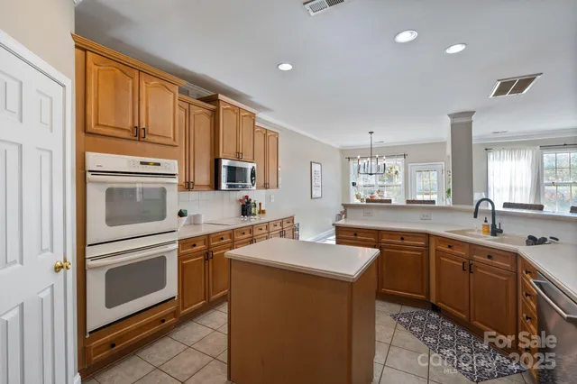 a kitchen with stainless steel appliances granite countertop a sink stove and cabinets