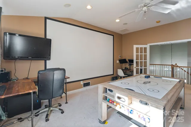 a work room with furniture and a flat screen tv