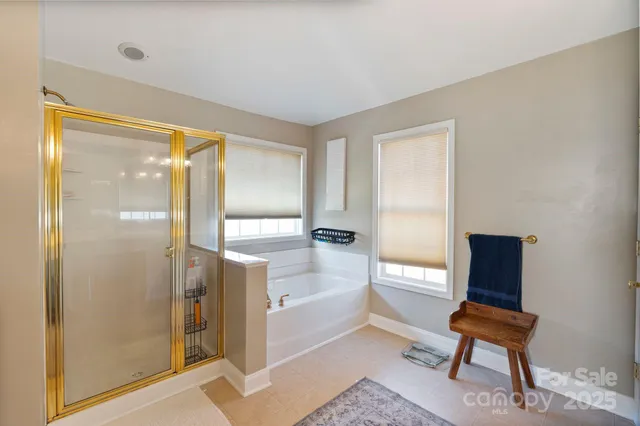 a bathroom with a bathtub and a chair
