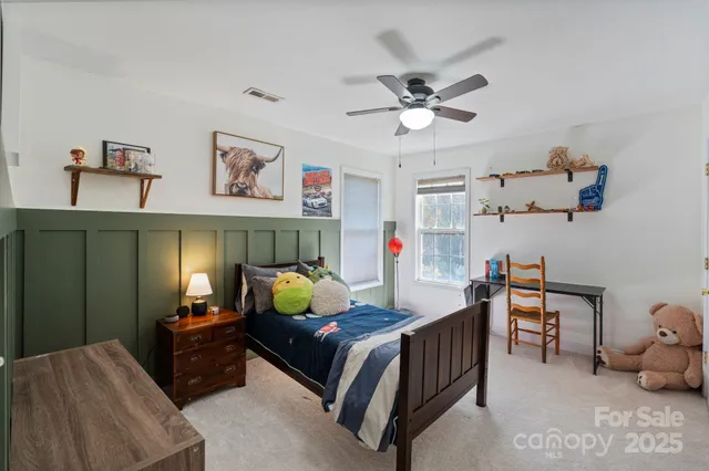 a bedroom with furniture and a chandelier