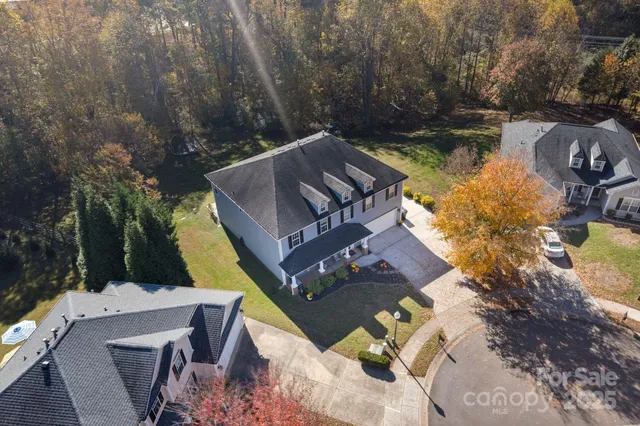 an aerial view of a house with a lake view