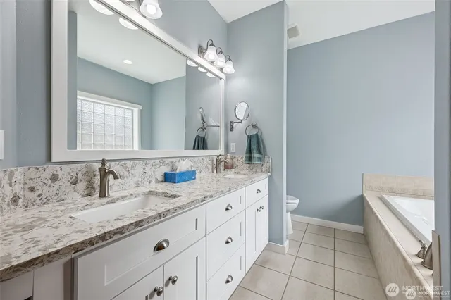 a bathroom with a bathtub and a window