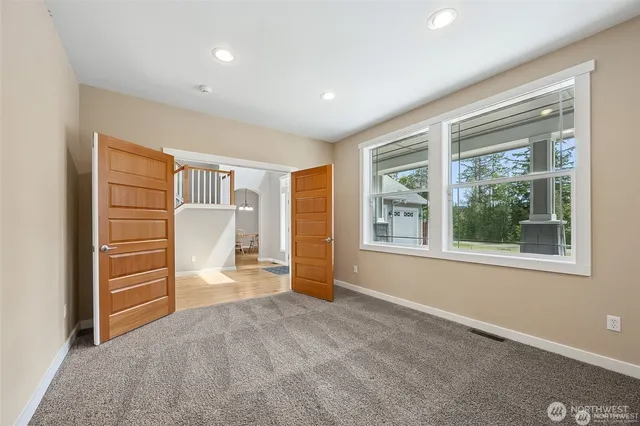 an empty room with windows closet and livingroom