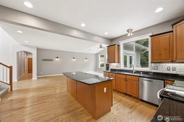 a kitchen with granite countertop counter top space a sink stainless steel appliances and cabinets
