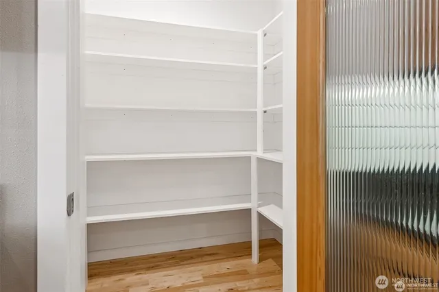 a view of walk in closet with empty racks