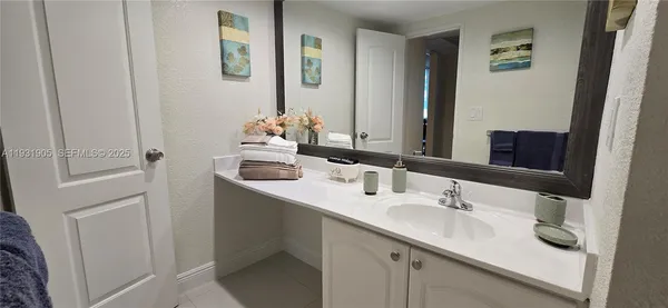 a room with gym equipment and wooden floor