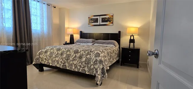 a bedroom with a bed and a night stand