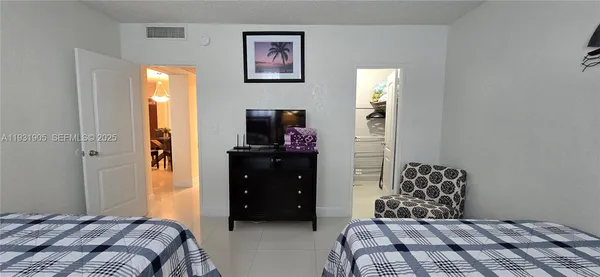 a living room with furniture a lamp and a window