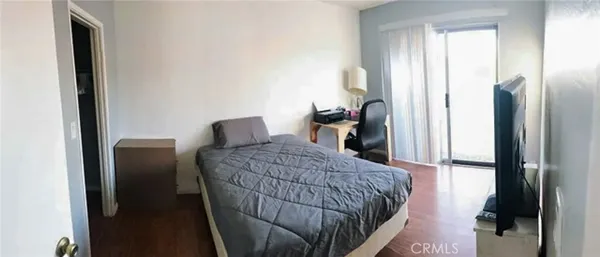 a bedroom with a bed and a mirror