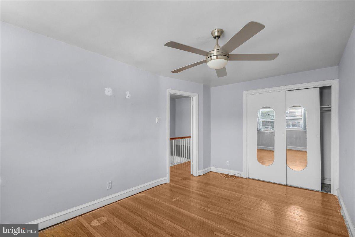 7823 Forrest Avenue Philadelphia, PA 19150 - Photo 11 of 27 a view of an empty room with wooden floor and a ceiling fan
