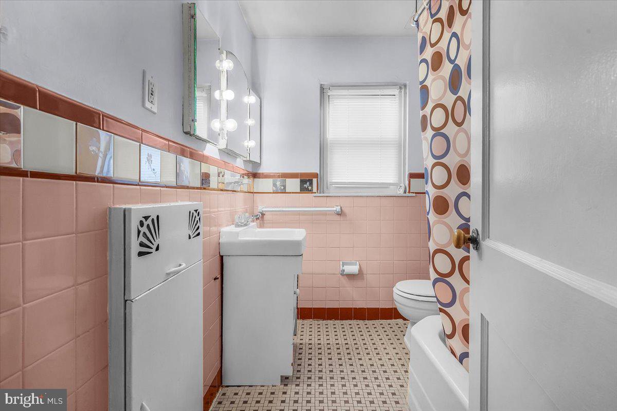 7823 Forrest Avenue Philadelphia, PA 19150 - Photo 13 of 27 a utility room with a sink a washer and dryer