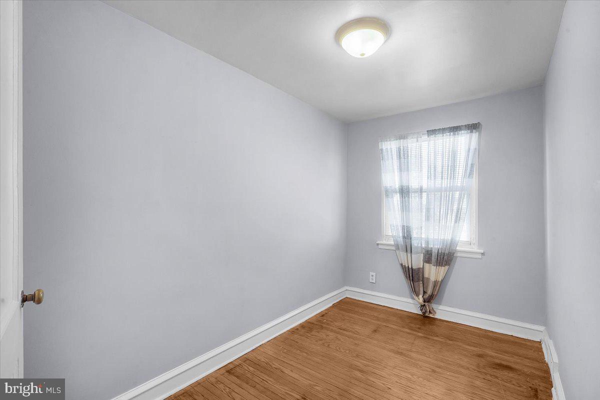 7823 Forrest Avenue Philadelphia, PA 19150 - Photo 16 of 27 an empty room with wooden floor and windows