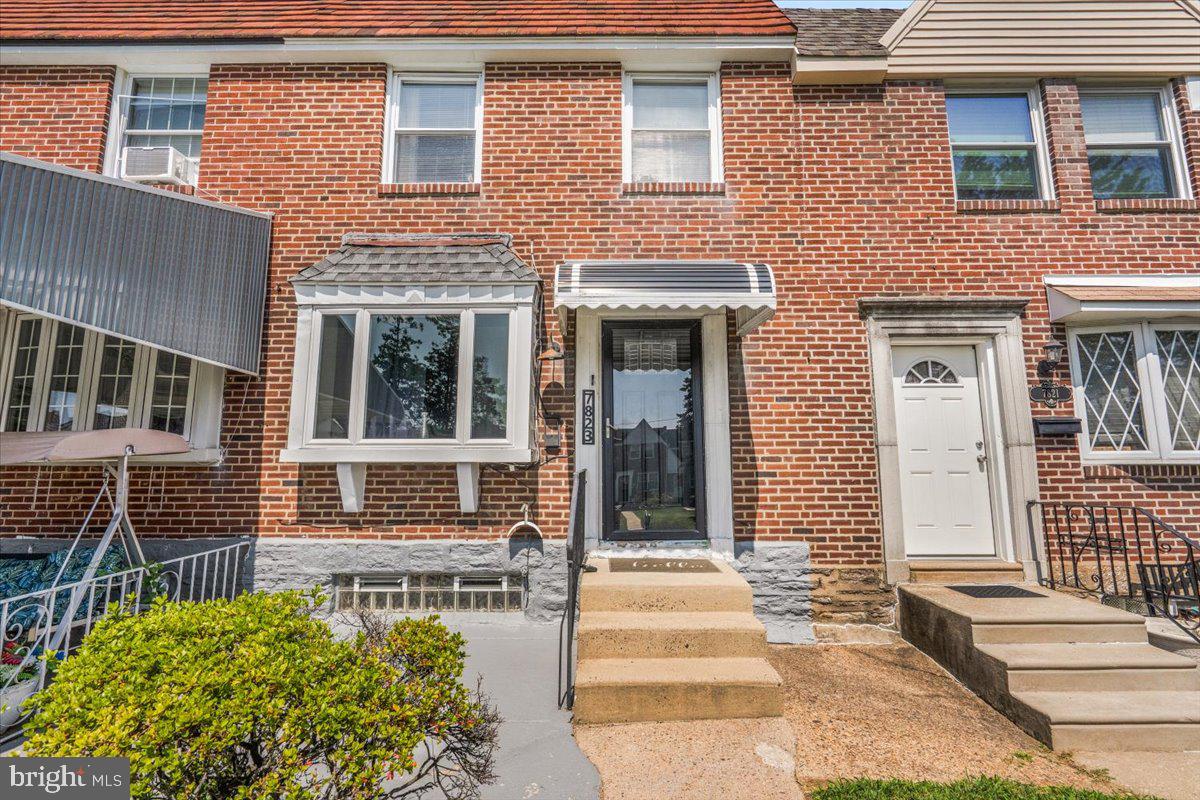 7823 Forrest Avenue Philadelphia, PA 19150 - Photo 26 of 27 a front view of a brick house with a large windows
