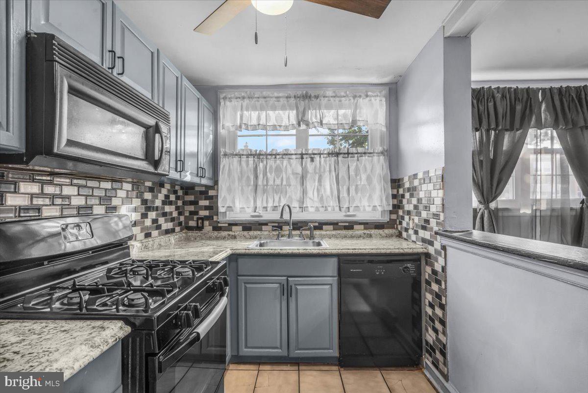 7823 Forrest Avenue Philadelphia, PA 19150 - Photo 4 of 27 a kitchen with a stove and a sink