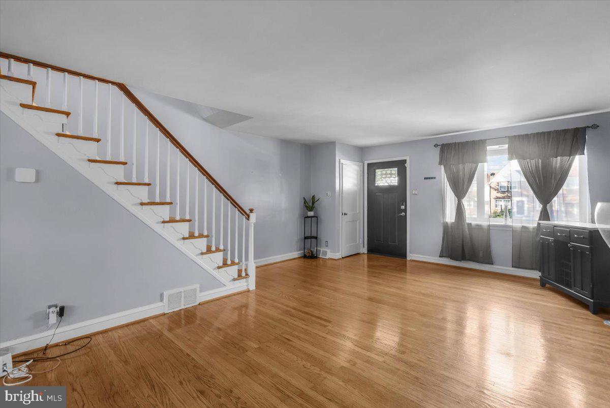 7823 Forrest Avenue Philadelphia, PA 19150 - Photo 6 of 27 a view of empty room with wooden floor and fan