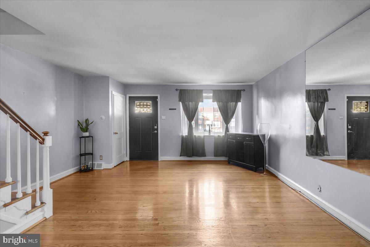 7823 Forrest Avenue Philadelphia, PA 19150 - Photo 7 of 27 a view of a livingroom with wooden floor and a bathroom